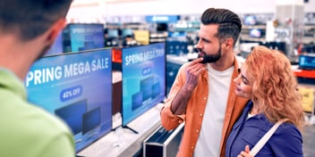 Couple shopping in electronics section at retail store
