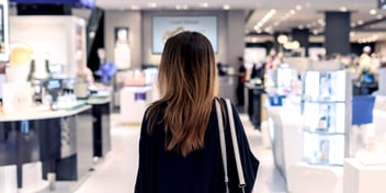 Woman starting at digital signage in a retail department store