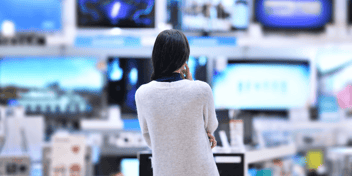 A woman engaged by a retail environment, meant to indicate the power of experiential retail