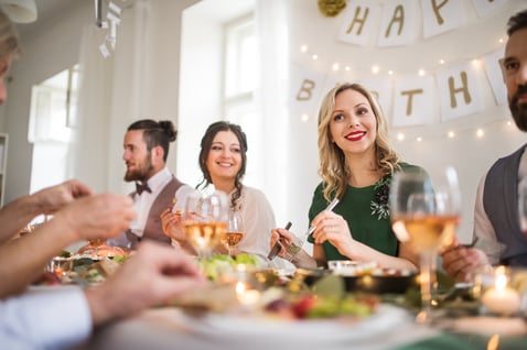 a-big-family-sitting-at-a-table-on-a-indoor-birthd-2022-02-02-04-50-35-utc