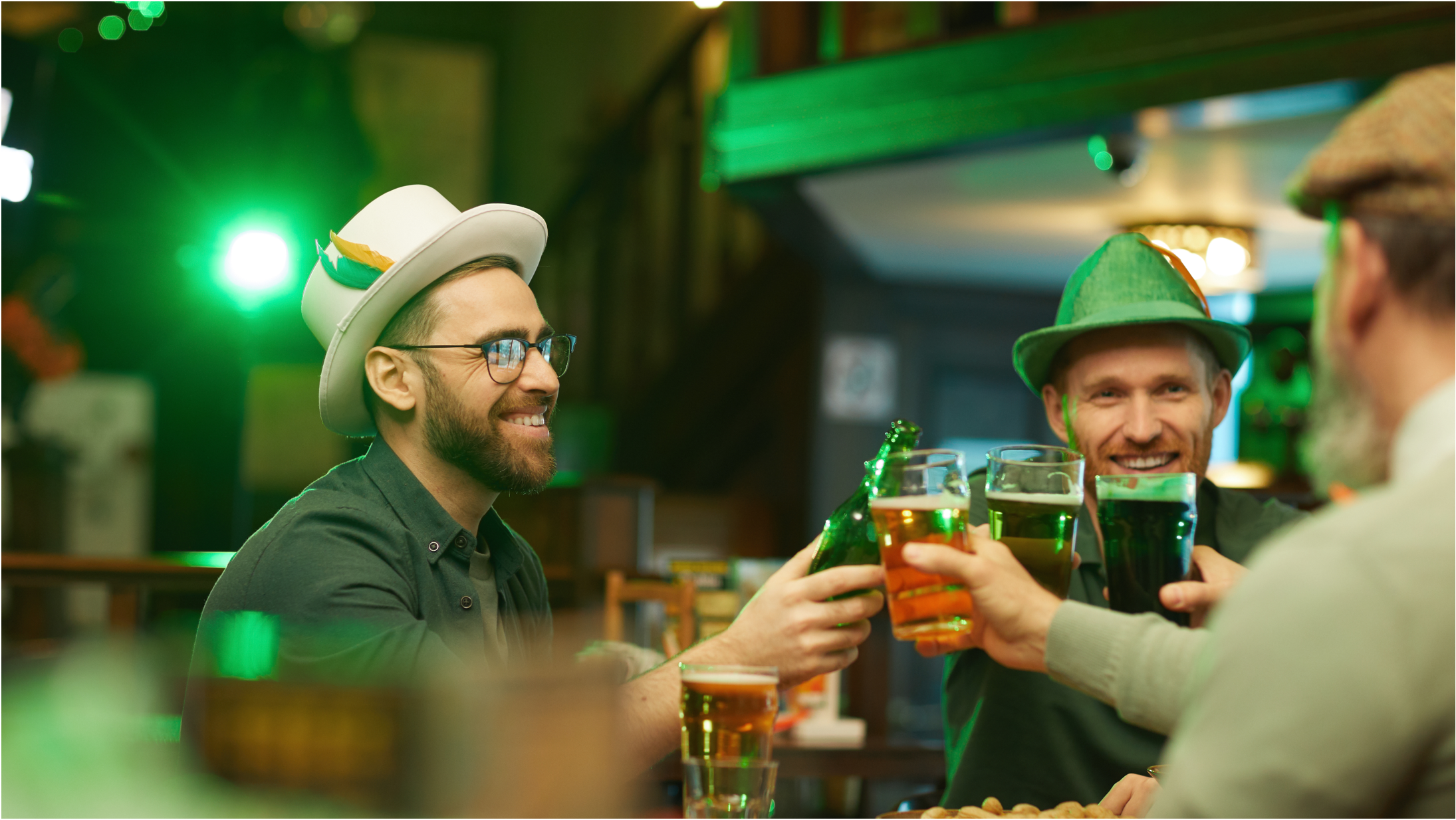 Men in festive attire drinking on St. Patrick's Day at a bar